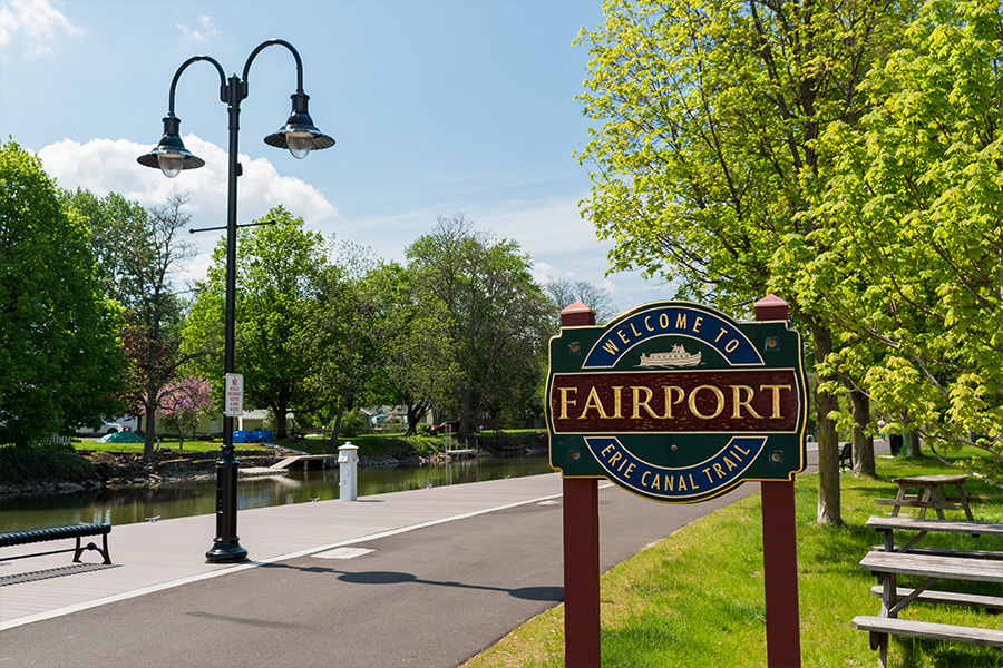 Afb Fairport A sign on a sidewalk by a canal. Fairport, ny