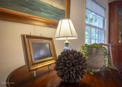 Interior photo of a table and paintings