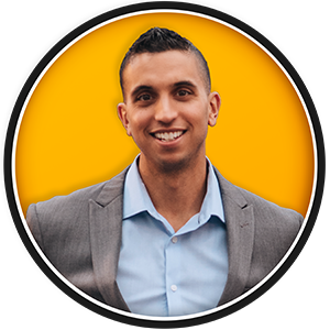 Jrr 2025 300Px V.2 Round headshot of james reyes in a grey suit with an orange background