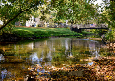 Serene creek with autumn foliage in brighton, ny.