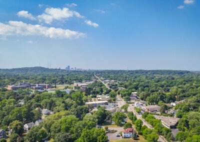 Brighton, ny. Aerial view of green suburban landscape with the city of rochester in the distance.
