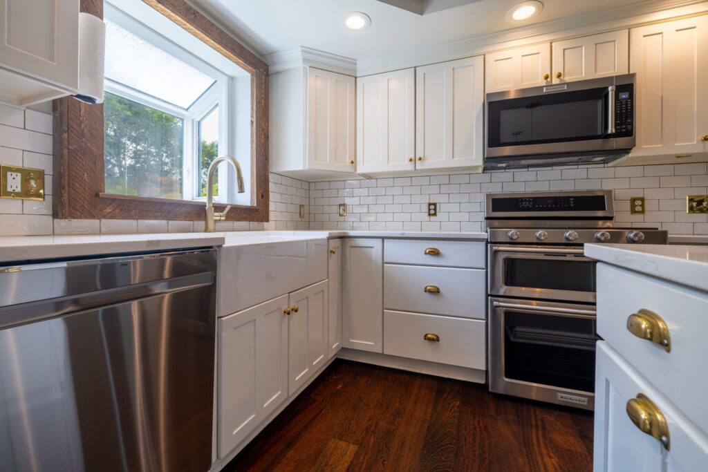 19 Warder Drive, Pittsford, Ny 14534 2 Remodeled kitchen featuring a quartz island, breakfast bar, double oven, and white cabinetry.
