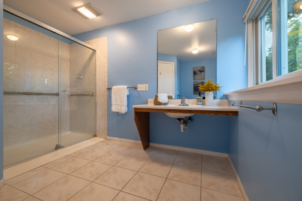 104 Ashley Dr, Rochester, NY 14620 3 Lower-level full bath at 104 Ashley Drive in Brighton, NY with accessible walk-in shower