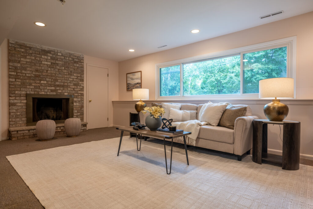 104 Ashley Dr, Rochester, NY 14620 4 Lower-level family room at 104 Ashley Drive in Brighton, NY with wood-burning brick fireplace