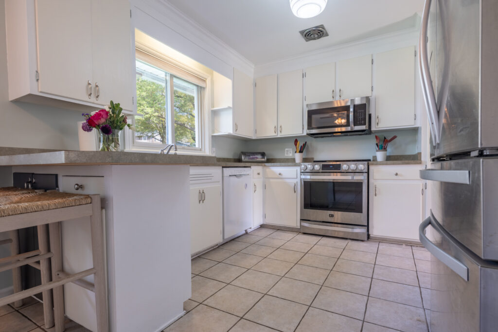 112 Burrows Hills Dr, Rochester, NY 14625 7 Eat-in kitchen with white cabinetry, stainless steel stove and refrigerator, and a window over the sink