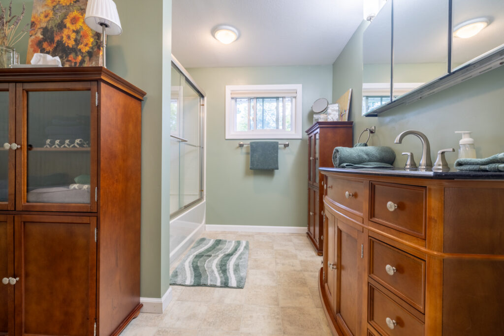 166 Moseley Rd, Fairport, NY 14450 7 Updated bathroom with vanity, mirrored cabinet and tub with shower at 166 Moseley Road.