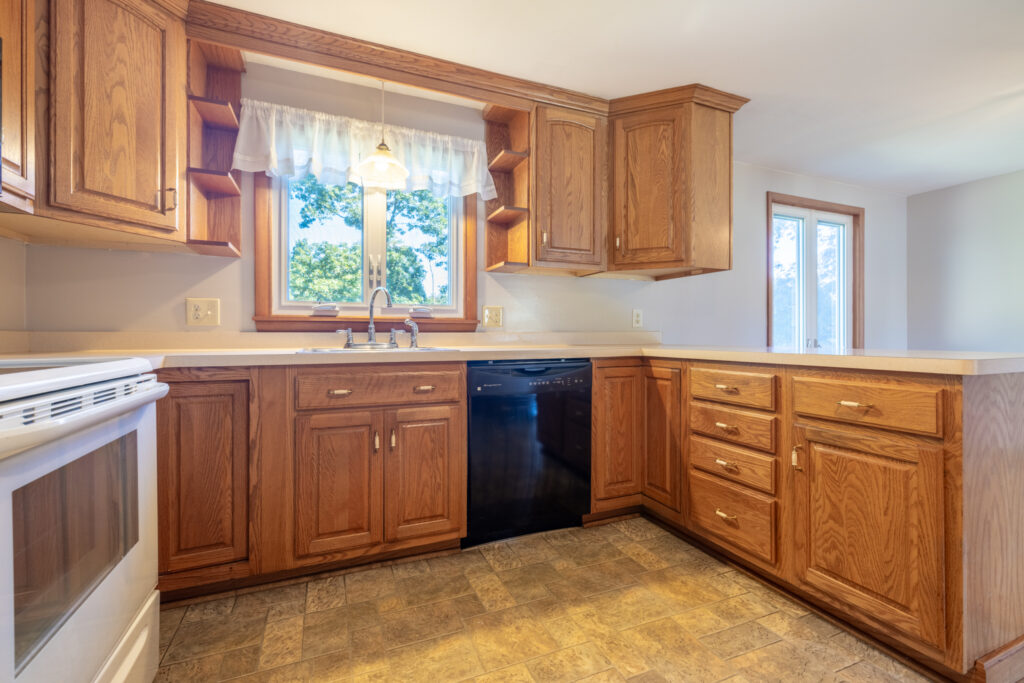 69 Cedarhurst Dr, West Henrietta, NY 14586 4 Kitchen at 69 Cedarhurst Drive with natural wood cabinets and a window above the sink.