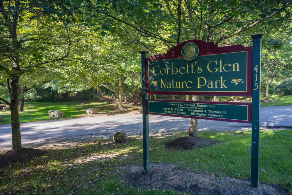 112 Burrows Hills Dr, Rochester, NY 14625 1 Corbett’s Glen Nature Park entrance sign beneath mature trees