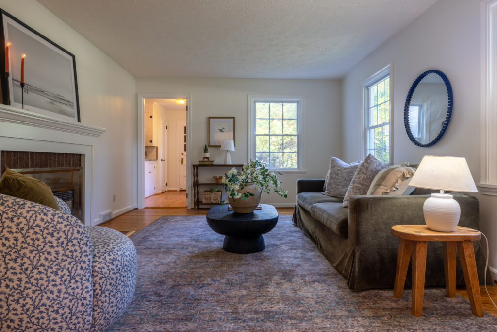 Bright living room with neutral walls, hardwood flooring and natural gas fireplace at 243 Overbrook Road Pittsford NY