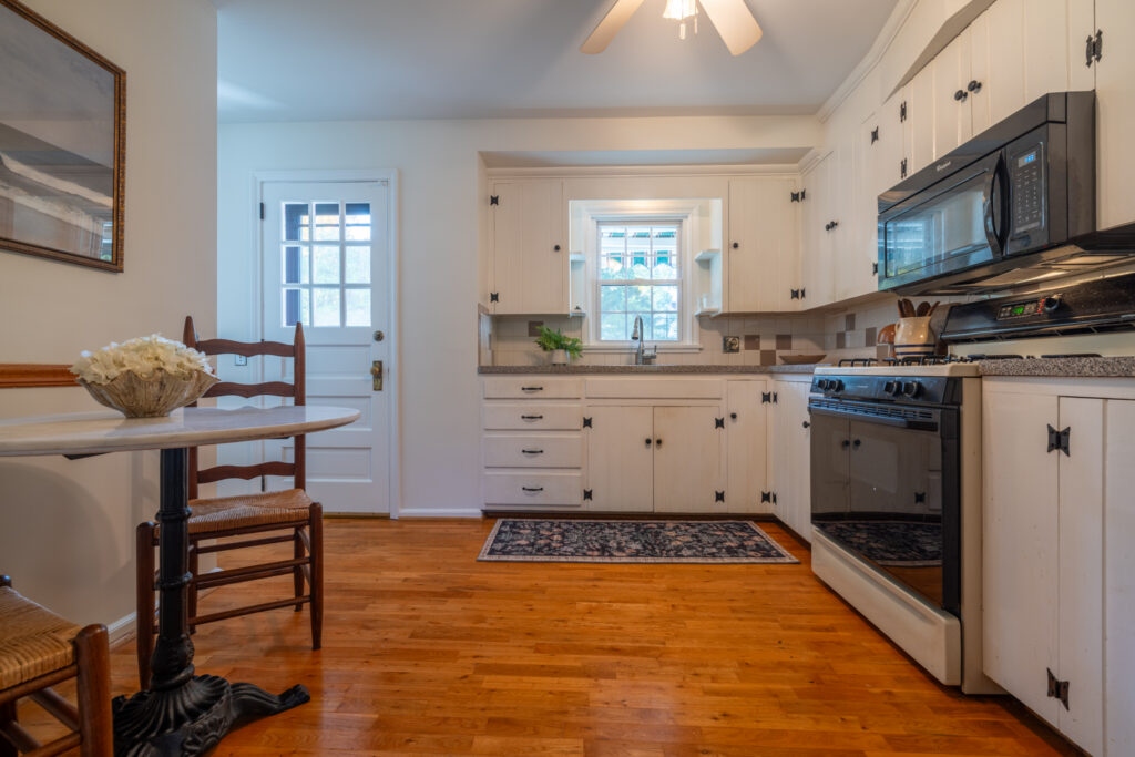 Traditional kitchen with white cabinetry, breakfast bar and natural light at 243 Overbrook Road in Pittsford NY